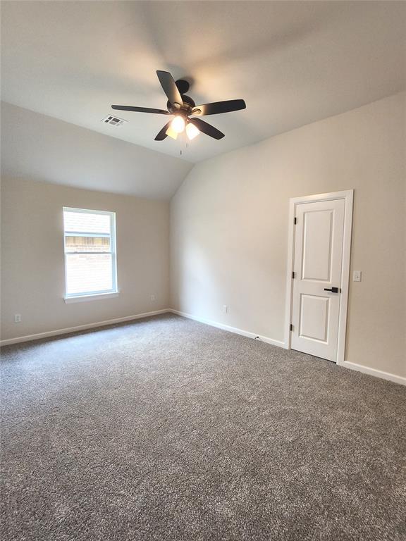 11613 NW 103rd St, Yukon, OK 73099 - carpeted empty room featuring ceiling fan, baseboards, and lofted ceiling