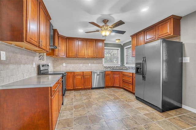 1724 N Lee St, Altus, OK 73521 - kitchen with brown cabinetry, ceiling fan, light countertops, appliances with stainless steel finishes, and tasteful backsplash