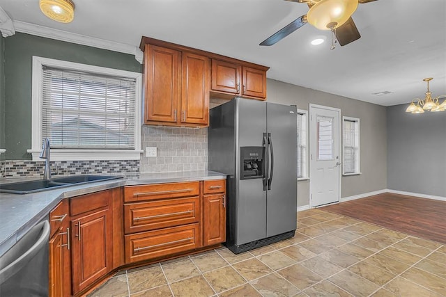 1724 N Lee St, Altus, OK 73521 - kitchen with backsplash, ceiling fan with notable chandelier, appliances with stainless steel finishes, and a sink