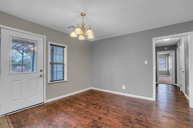 1724 N Lee St, Altus, OK 73521 - foyer featuring a notable chandelier, plenty of natural light, visible vents, and wood finished floors