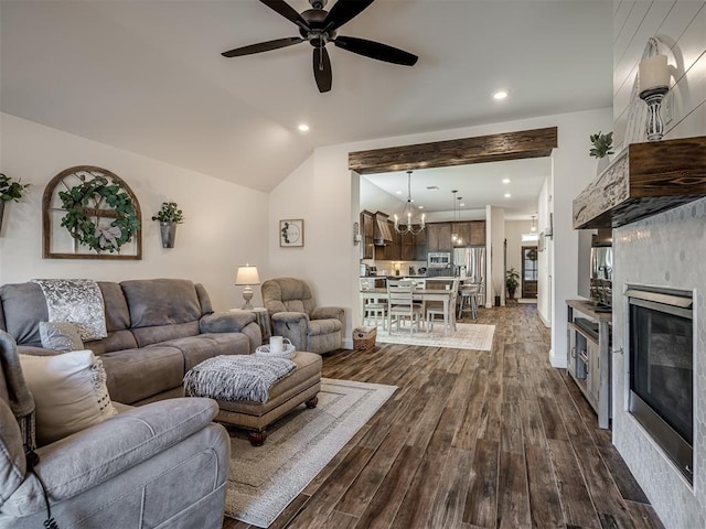 16304 Steppe Dr, Oklahoma City, OK 73170 - living room featuring dark wood-style floors, a ceiling fan, a glass covered fireplace, vaulted ceiling, and a chandelier