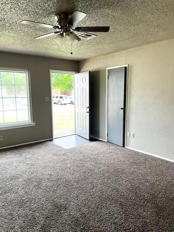 2513 N Nottingham Way, Moore, OK 73160 - carpeted spare room featuring a textured wall, a textured ceiling, healthy amount of natural light, and ceiling fan