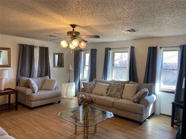 2416 SW 92nd St, Oklahoma City, OK 73159 - living room with light wood-style flooring, visible vents, ceiling fan, and plenty of natural light