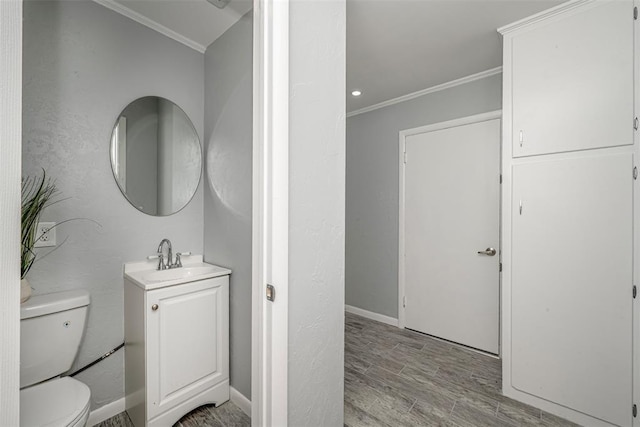 3316 NW 60th, Oklahoma City, OK 73112 - bathroom featuring wood finished floors, crown molding, vanity, and toilet