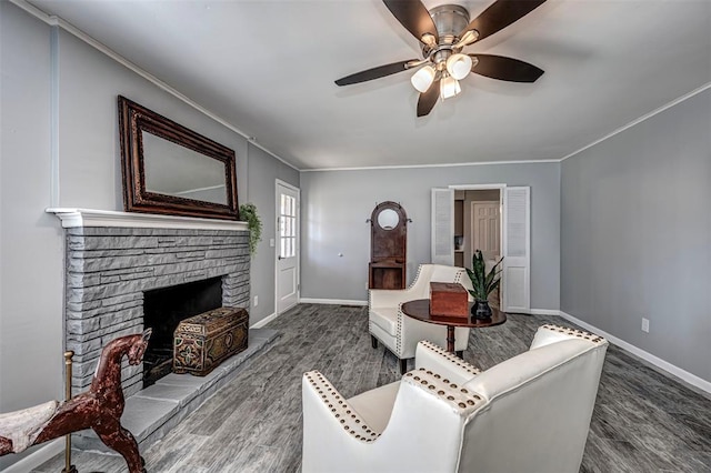 3316 NW 60th, Oklahoma City, OK 73112 - living room with a ceiling fan, a stone fireplace, ornamental molding, and wood finished floors