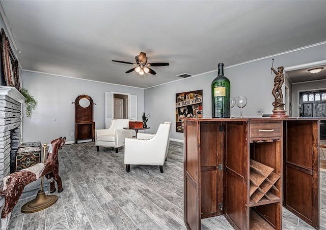 3316 NW 60th, Oklahoma City, OK 73112 - living room featuring a stone fireplace, visible vents, a ceiling fan, wood finished floors, and baseboards