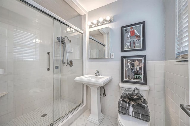 3316 NW 60th, Oklahoma City, OK 73112 - full bathroom with tile patterned floors, a stall shower, tile walls, a wainscoted wall, and toilet