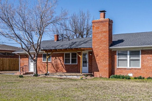 3316 NW 60th, Oklahoma City, OK 73112 - back of property with fence, a chimney, brick siding, and a yard