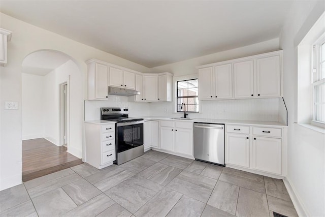 1721 NW 35th St, Oklahoma City, OK 73118 - kitchen with under cabinet range hood, light countertops, appliances with stainless steel finishes, white cabinets, and a sink