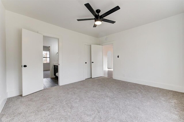 1721 NW 35th St, Oklahoma City, OK 73118 - unfurnished bedroom featuring ceiling fan, baseboards, ensuite bathroom, and carpet