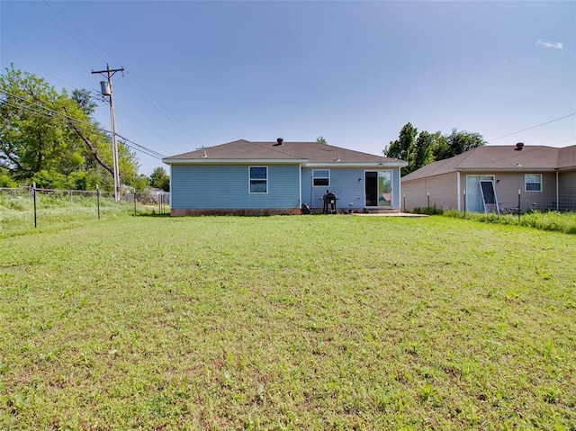 1415 NW 98th St, Oklahoma City, OK 73114 - rear view of house with a lawn and fence