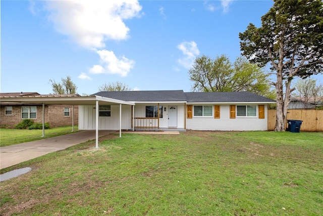 105 Moran Dr, Anadarko, OK 73005 - ranch-style house with a porch, a carport, a front yard, fence, and driveway