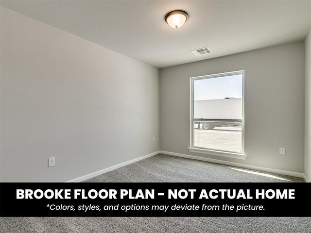 carpeted spare room with visible vents and baseboards