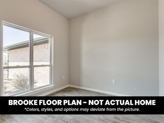 unfurnished room with baseboards and wood finished floors