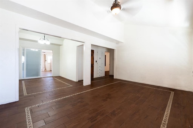 2935 NW Grand Blvd, Oklahoma City, OK 73116 - spare room with baseboards, high vaulted ceiling, wood finished floors, and ceiling fan with notable chandelier