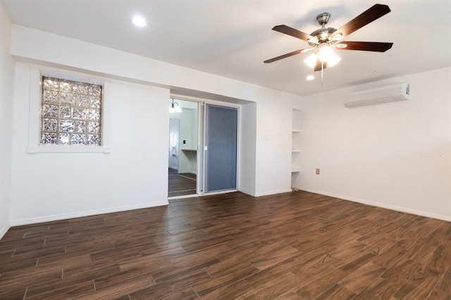 2935 NW Grand Blvd, Oklahoma City, OK 73116 - empty room with dark wood finished floors, baseboards, a wall mounted AC, and a ceiling fan