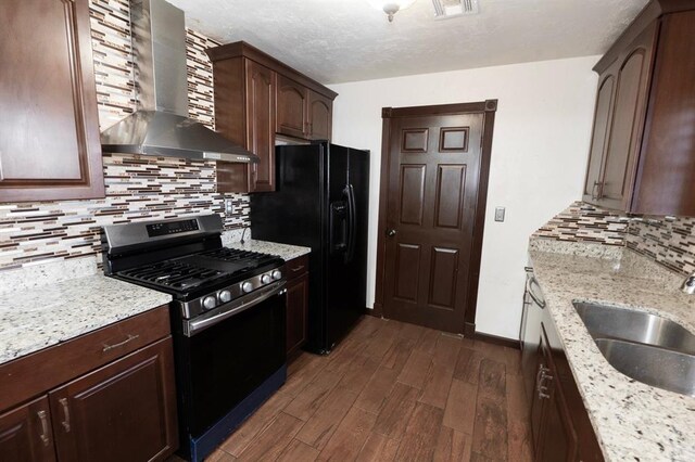 2935 NW Grand Blvd, Oklahoma City, OK 73116 - kitchen with a sink, dark wood-style floors, wall chimney range hood, dark brown cabinets, and stainless steel range with gas stovetop