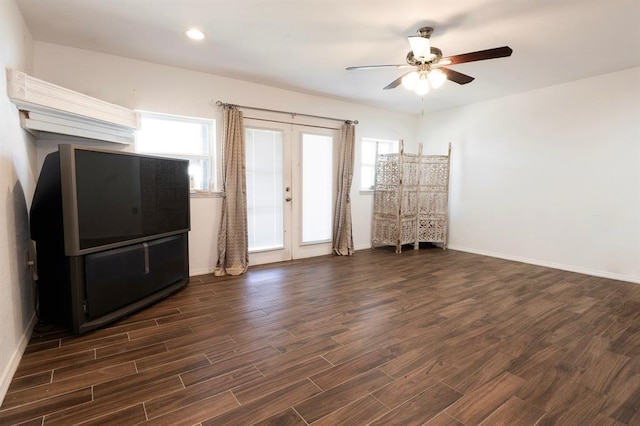 2935 NW Grand Blvd, Oklahoma City, OK 73116 - unfurnished living room featuring a wealth of natural light, french doors, dark wood finished floors, and a ceiling fan