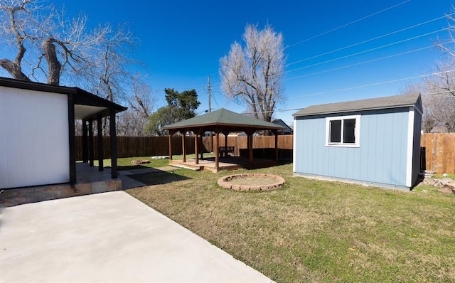 2935 NW Grand Blvd, Oklahoma City, OK 73116 - view of yard featuring an outbuilding, a patio, a fenced backyard, a gazebo, and a storage unit