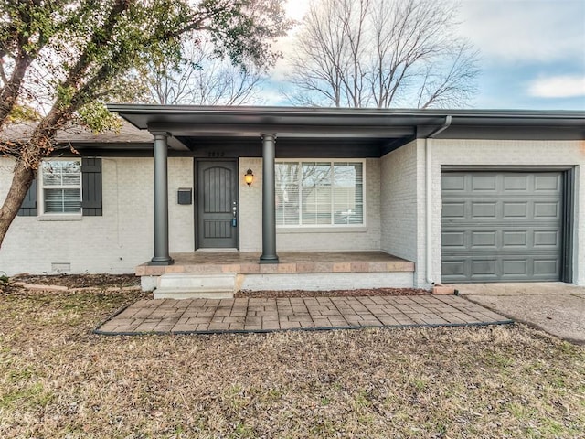 2832 Warwick Dr, Oklahoma City, OK 73116 - view of front of property with a garage, brick siding, a porch, and concrete driveway