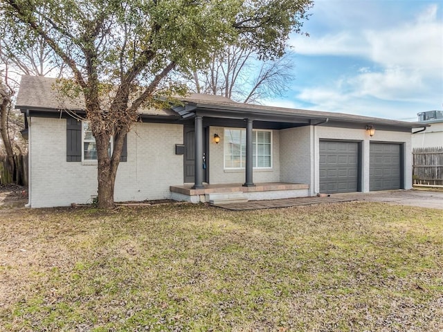 2832 Warwick Dr, Oklahoma City, OK 73116 - ranch-style home with a garage, brick siding, driveway, and fence