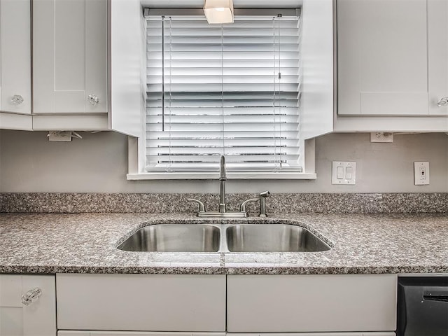 2832 Warwick Dr, Oklahoma City, OK 73116 - kitchen with dishwasher, white cabinetry, dark stone counters, and a sink