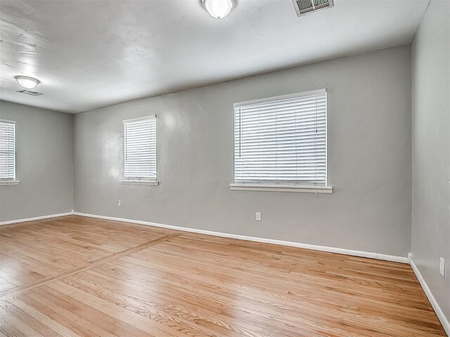 2832 Warwick Dr, Oklahoma City, OK 73116 - unfurnished room with visible vents, baseboards, and wood finished floors