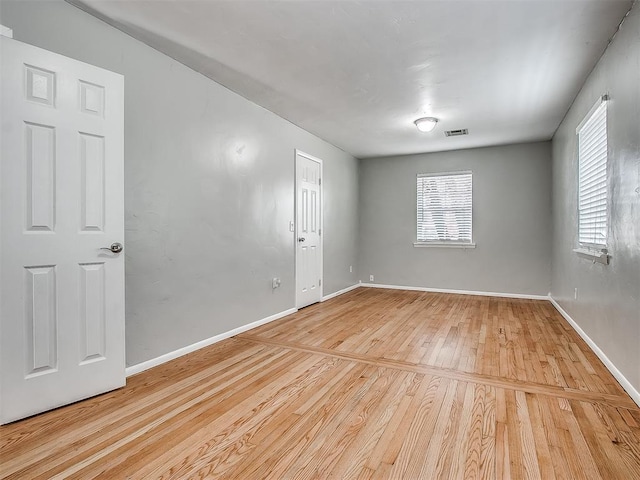 2832 Warwick Dr, Oklahoma City, OK 73116 - spare room featuring light wood finished floors, visible vents, and baseboards