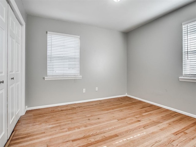 2832 Warwick Dr, Oklahoma City, OK 73116 - unfurnished bedroom with baseboards, a closet, and light wood-type flooring