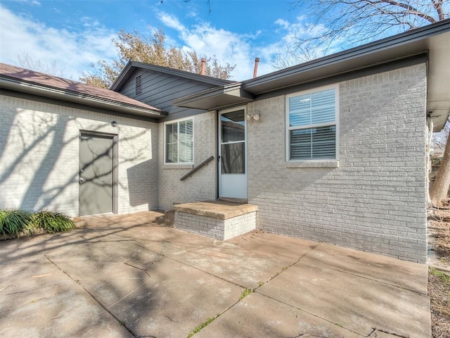 2832 Warwick Dr, Oklahoma City, OK 73116 - back of house with a patio area and brick siding