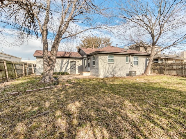 2832 Warwick Dr, Oklahoma City, OK 73116 - back of house with a yard, a fenced backyard, and central AC