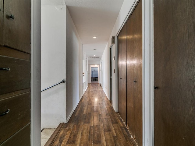 hall with dark wood-style floors and baseboards
