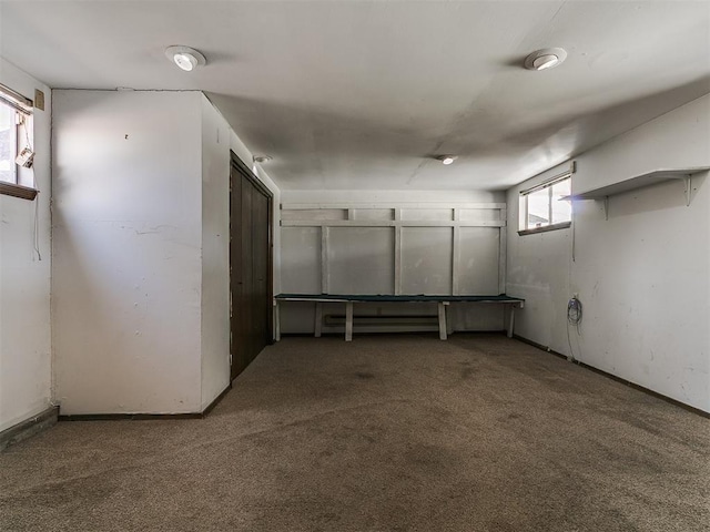 basement featuring baseboards and carpet
