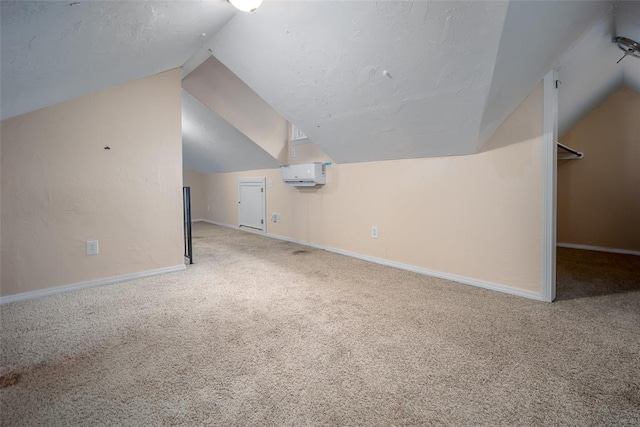 4505 N Peniel Ave, Bethany, OK 73008 - additional living space with carpet flooring, lofted ceiling, a wall unit AC, and a textured ceiling