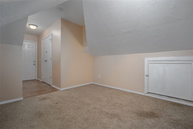 4505 N Peniel Ave, Bethany, OK 73008 - additional living space with carpet floors, vaulted ceiling, and a textured ceiling