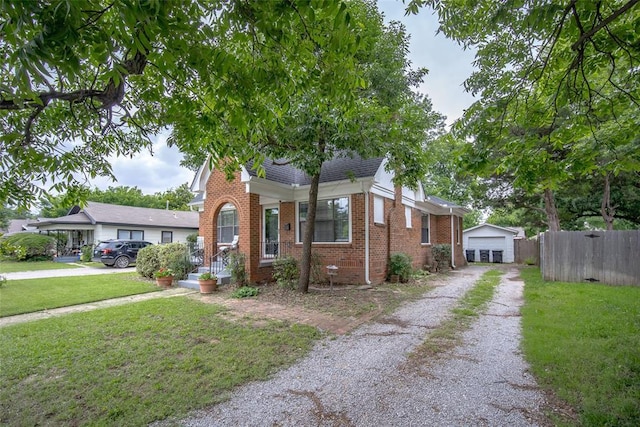 4505 N Peniel Ave, Bethany, OK 73008 - view of front of property featuring brick siding, a detached garage, driveway, and an outbuilding