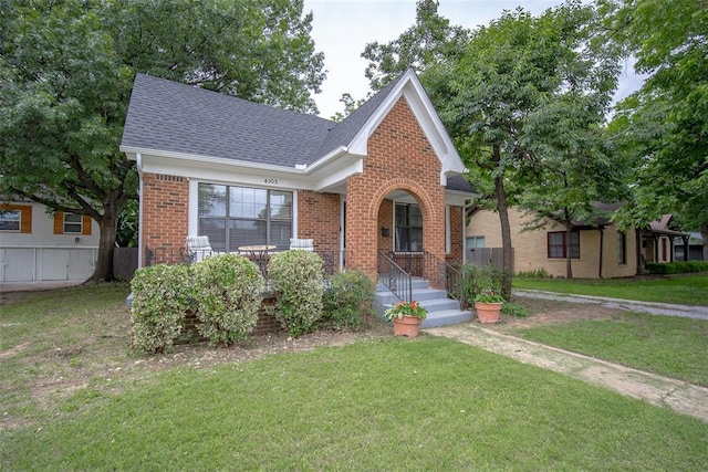 4505 N Peniel Ave, Bethany, OK 73008 - view of front of property featuring brick siding, a shingled roof, and a front yard
