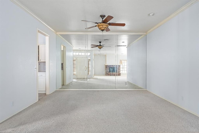 carpeted spare room featuring a ceiling fan, french doors, and ornamental molding