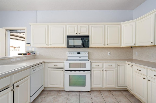 kitchen featuring a sink, white appliances, light tile patterned floors, and light countertops