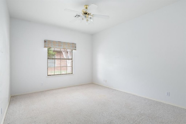 spare room with carpet floors and ceiling fan
