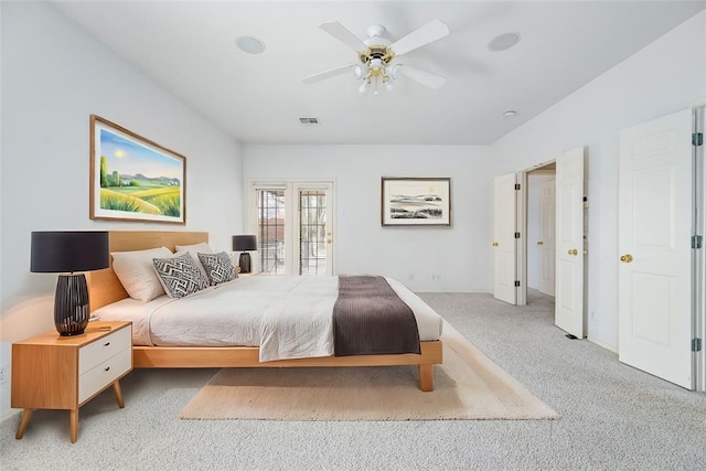 carpeted bedroom with visible vents and ceiling fan