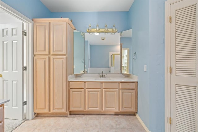 bathroom featuring tile patterned floors, a closet, baseboards, and vanity