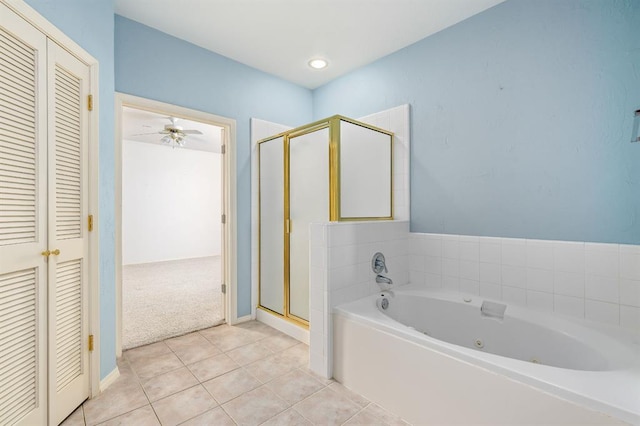 bathroom with a ceiling fan, a tub with jets, a stall shower, a closet, and tile patterned floors