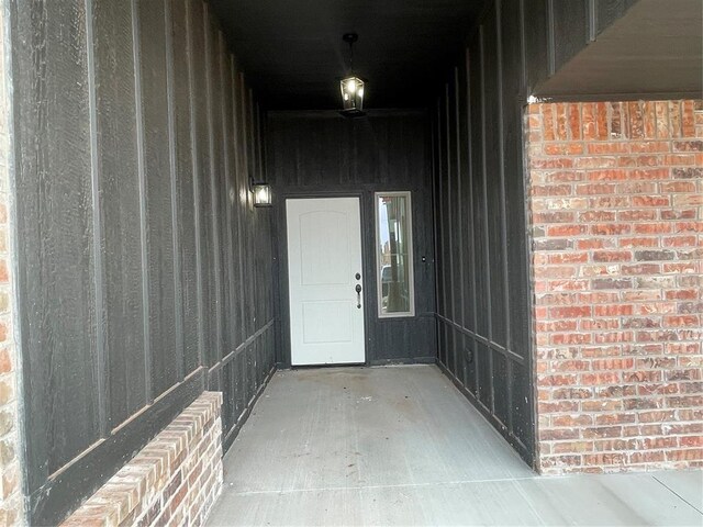 doorway to property with brick siding
