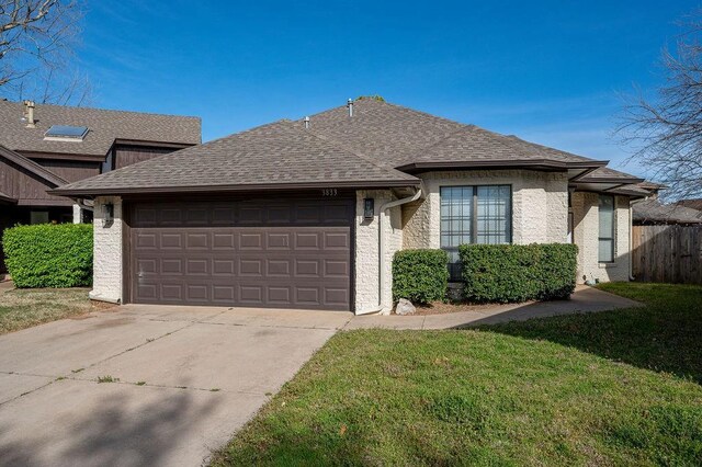 3833 Ives Way, Norman, OK 73072 - view of front of home with a garage, driveway, and roof with shingles