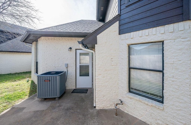3833 Ives Way, Norman, OK 73072 - entrance to property featuring cooling unit and a shingled roof