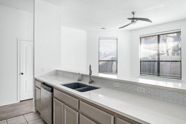 3833 Ives Way, Norman, OK 73072 - kitchen featuring stainless steel dishwasher, a sink, light countertops, ceiling fan, and light tile patterned floors