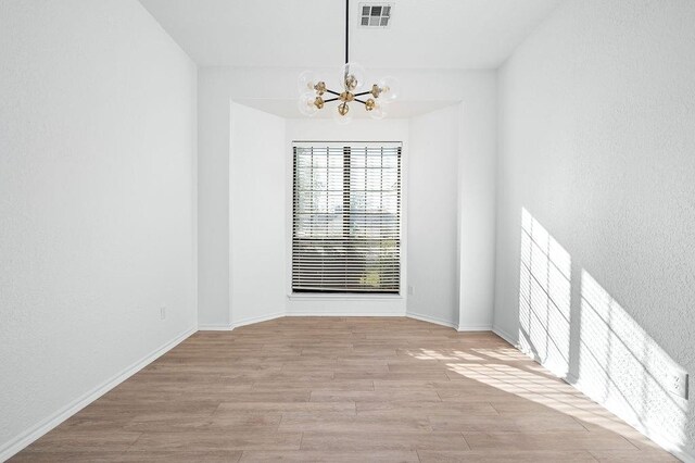 3833 Ives Way, Norman, OK 73072 - unfurnished room with a chandelier, wood finished floors, and baseboards
