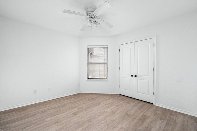 3833 Ives Way, Norman, OK 73072 - unfurnished bedroom with light wood-style floors, a closet, baseboards, and a ceiling fan