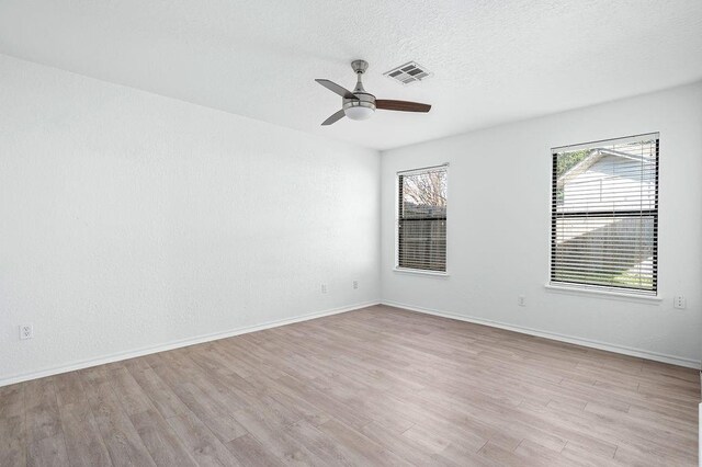 3833 Ives Way, Norman, OK 73072 - spare room with a ceiling fan, light wood finished floors, baseboards, and a textured ceiling